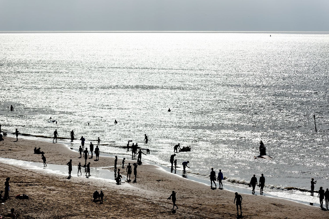 Beachgoers and bathers at Scheveningen on a hot summers day. Shot from atop The Pier.