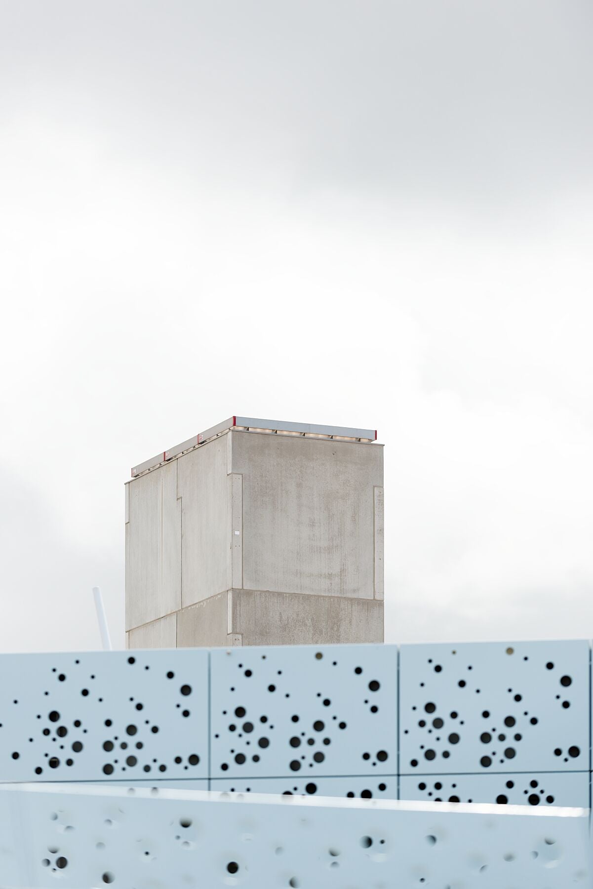 Concrete, the sky, and a modern facade on the beach at Schevenignen