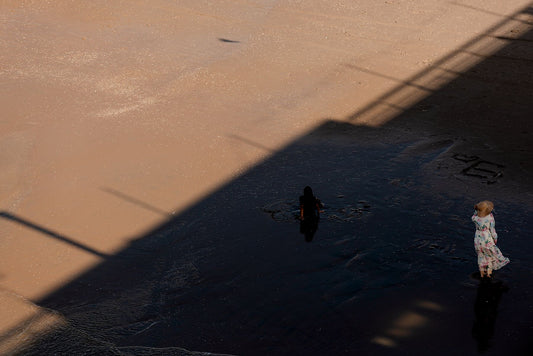 A woman and child on the beach at Scheveningen in this moody fine art print.