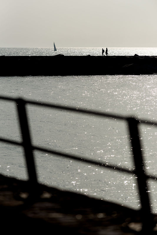 The harbour wall at Scheveningen captured in dramatic late afternoon light.