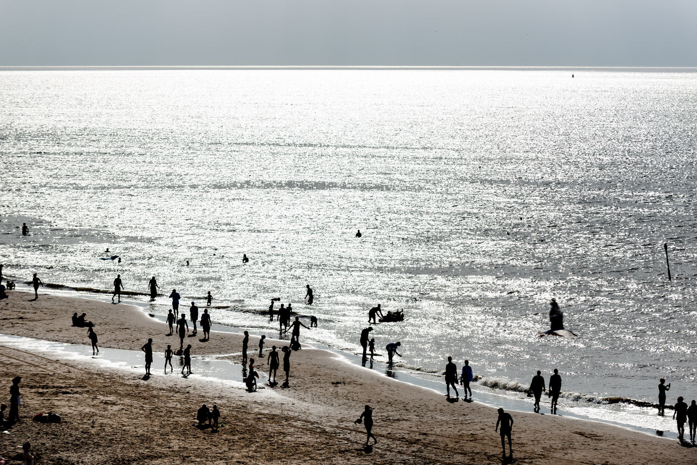 Swimmers and walkers enjoy the beach at Scheveningen