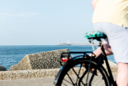 A biker cycles past on the harbour wall at Scheveningen.