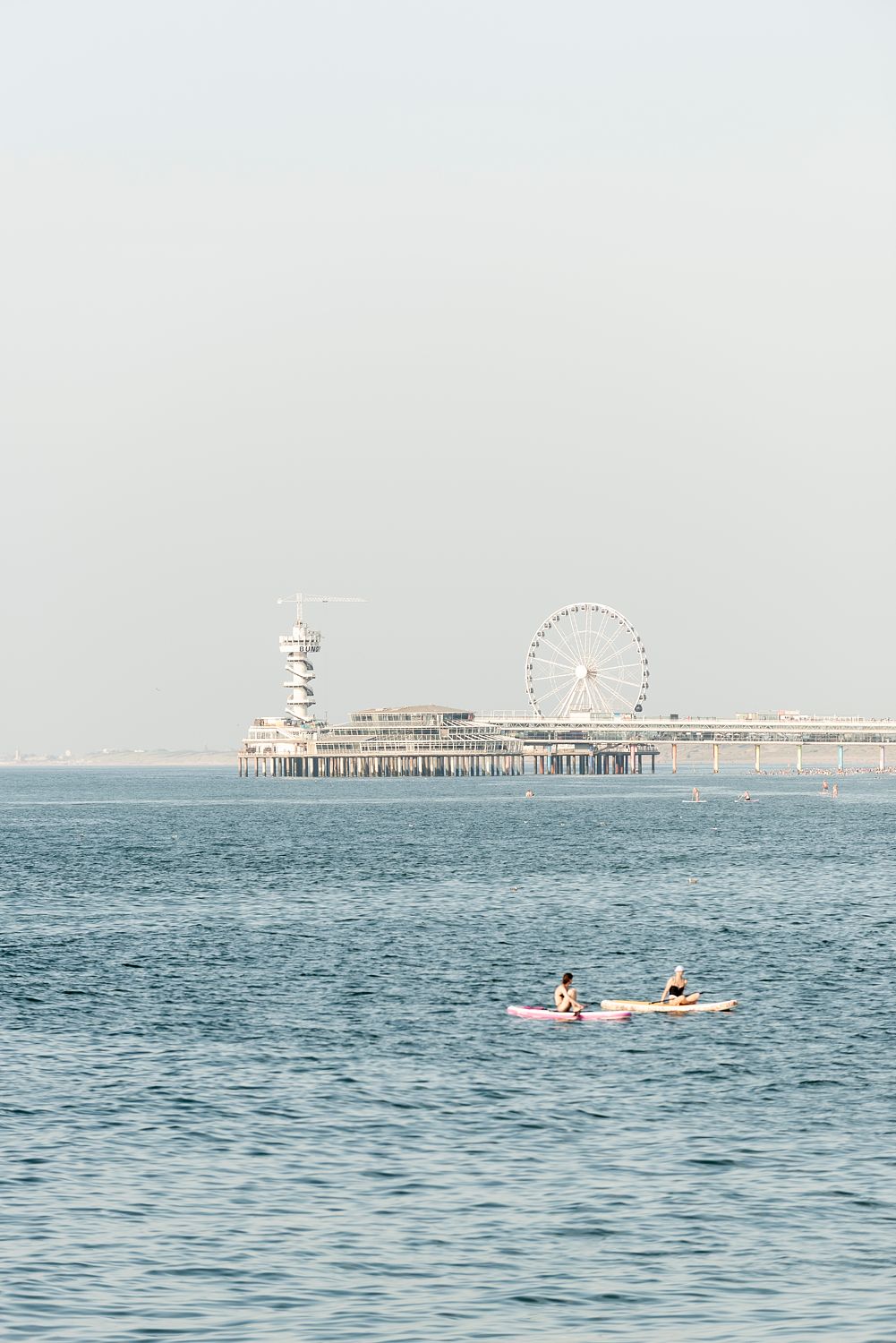 Paddle boarders float in the North Sea near Scheveningen.