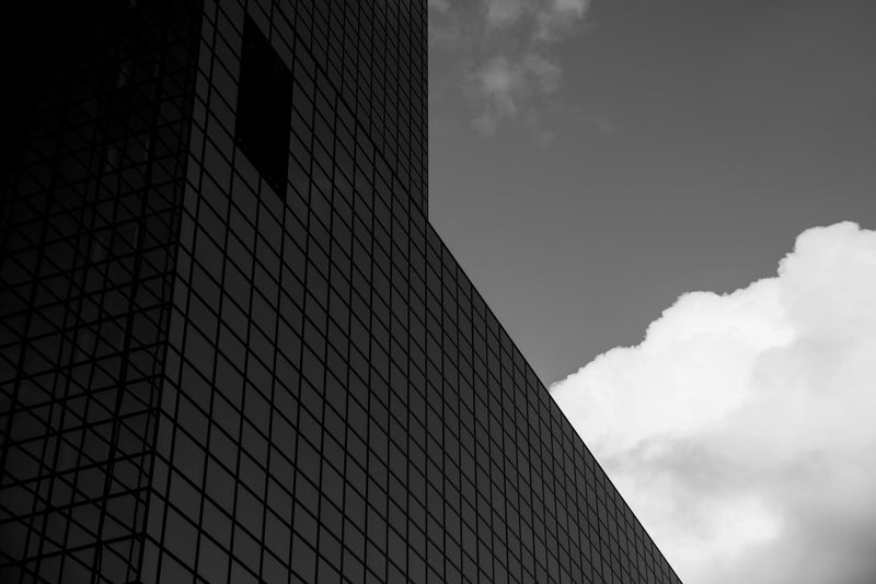 A dramatic sky framed by a high rise building in Rotterdam.