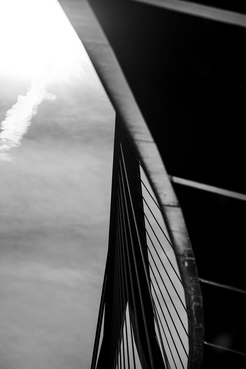 An architectural detail in black and white of the Erasmusbrug