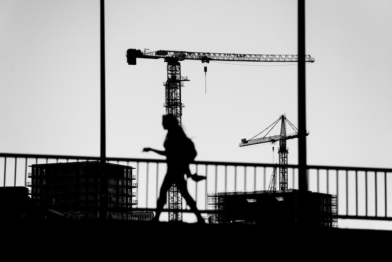 A woman crossing a walkway near Rotterdam Blaak.