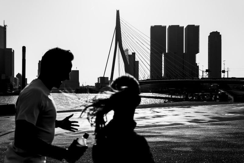A couple run along the bank of the Nieuwe Maas river.