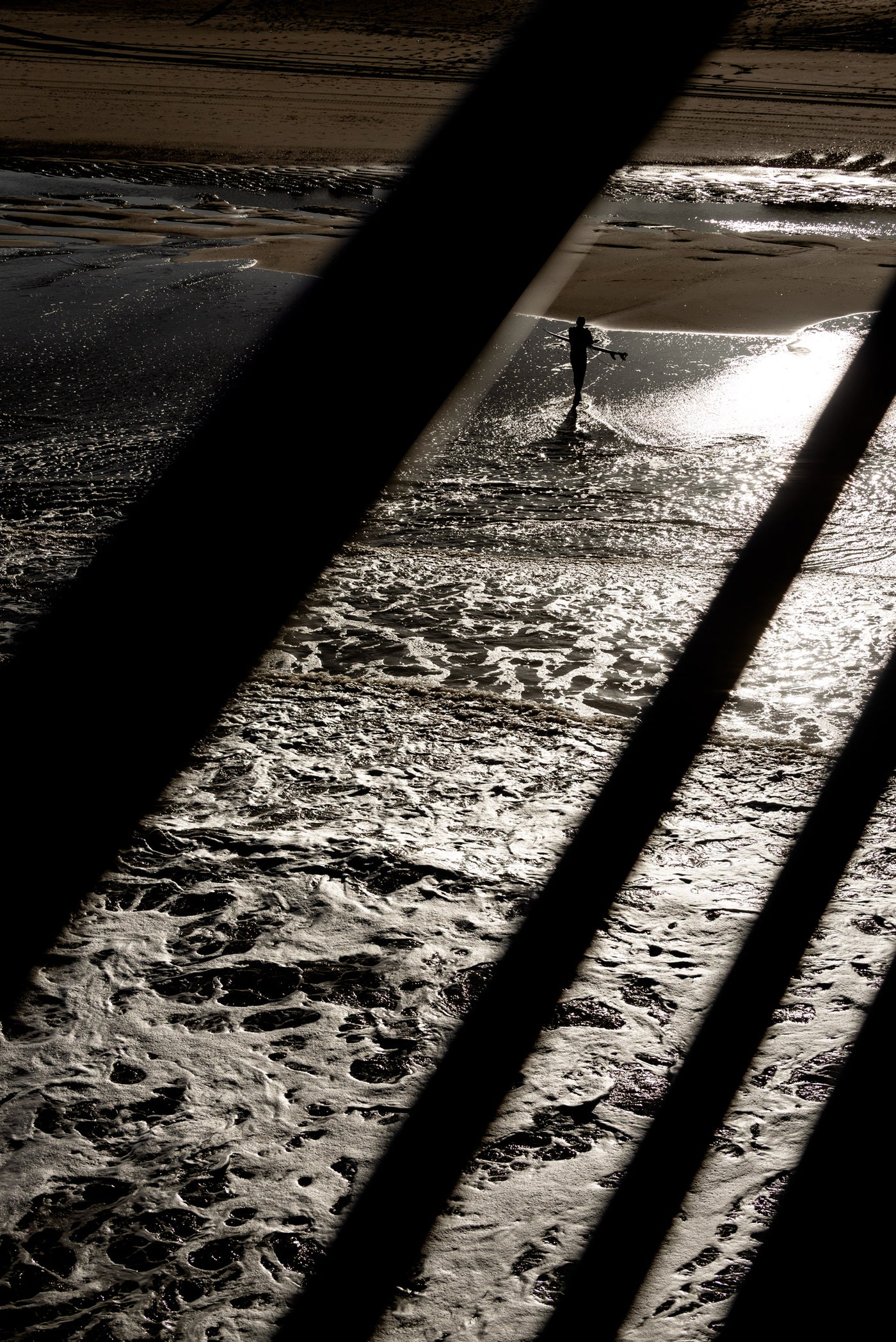 A surfer exits the water at Scheveningen.