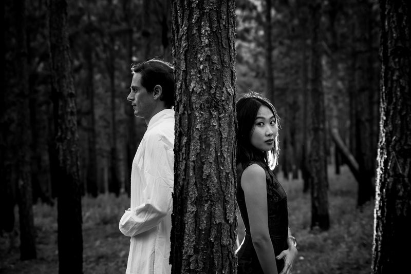 Young couple photographed in portraiture shoot in the forest.