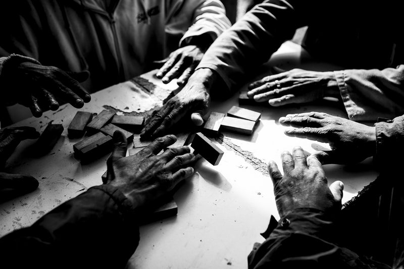 Men play a informal gambling game in South Africa.