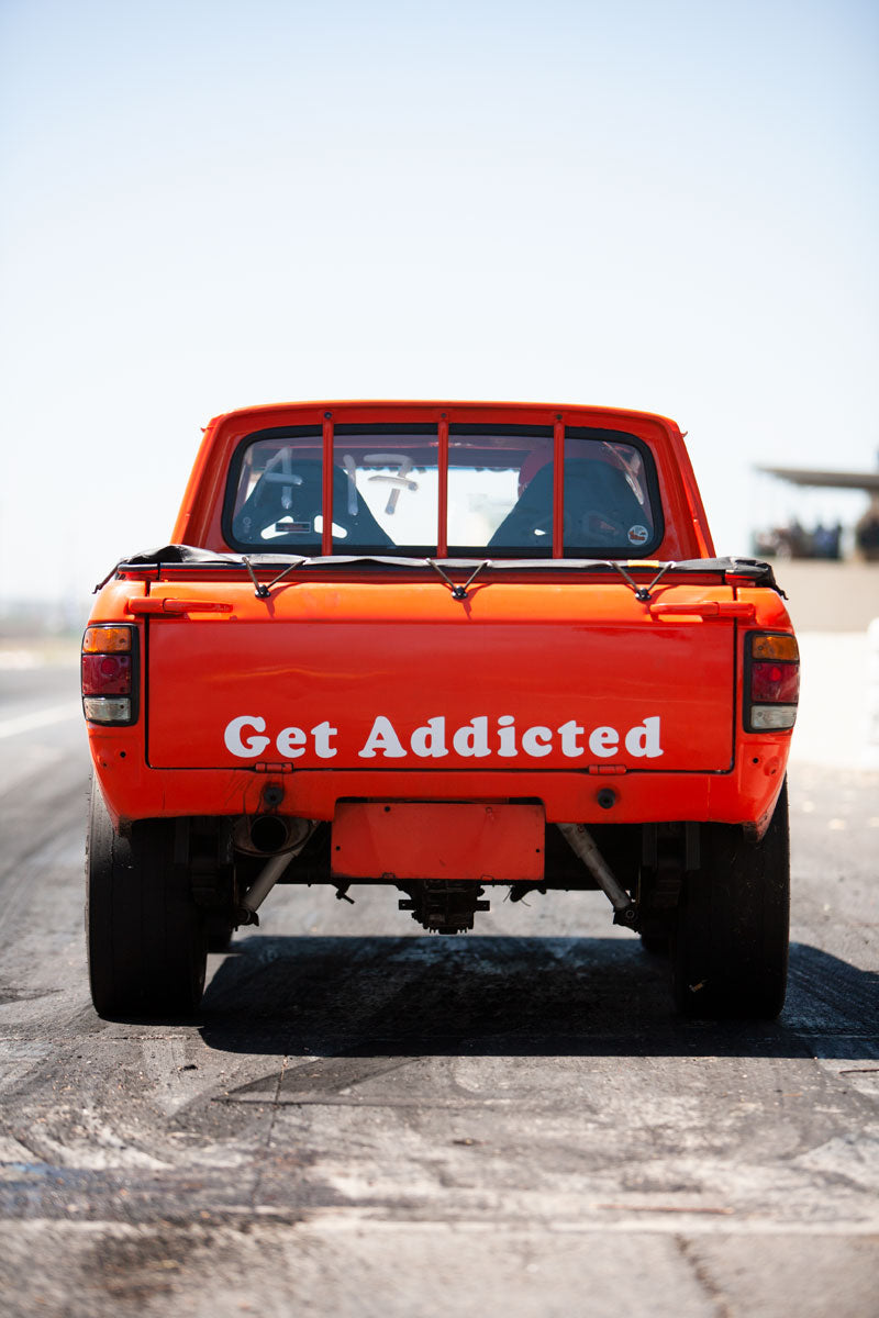 Reportage photograph of a drag racing car at an amateur drag racing event.