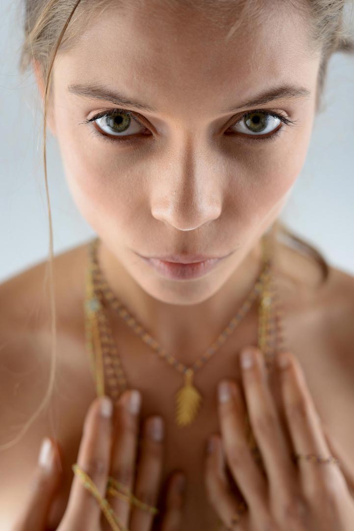 Young woman with jewellery for fashion shoot.