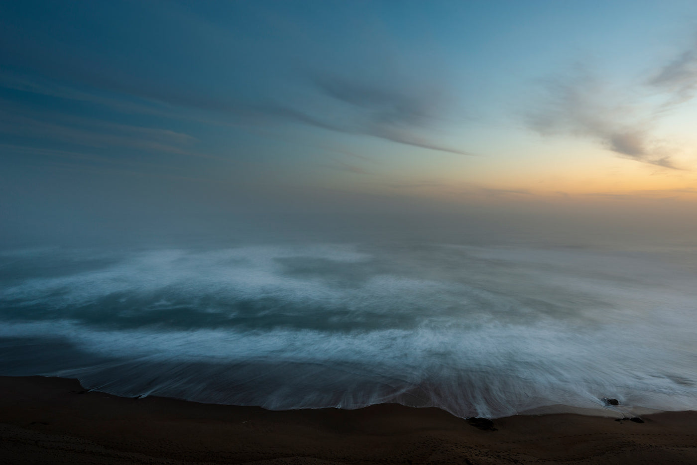 Sun setting over moving water at Wilderness, South Africa.