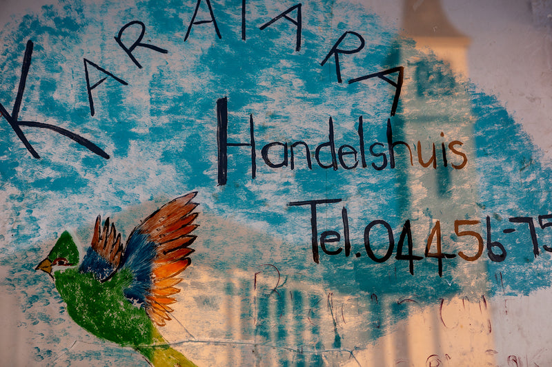 A image of a shopfront with reflections in Karatara