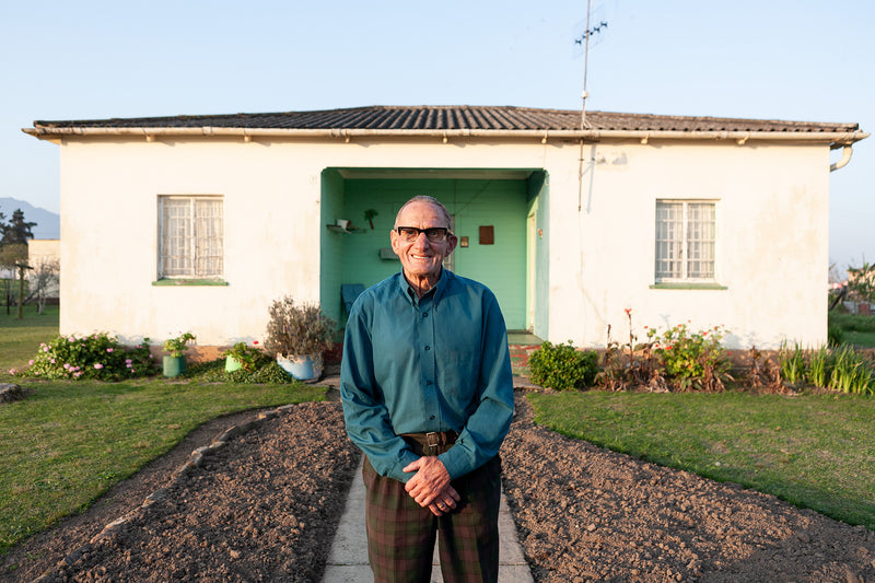 A man in front of his house in Karatara