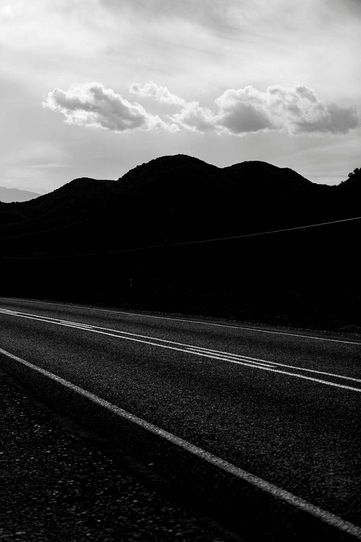 A moody and dark photograph in black and white of Route 62 in the Little Karoo
