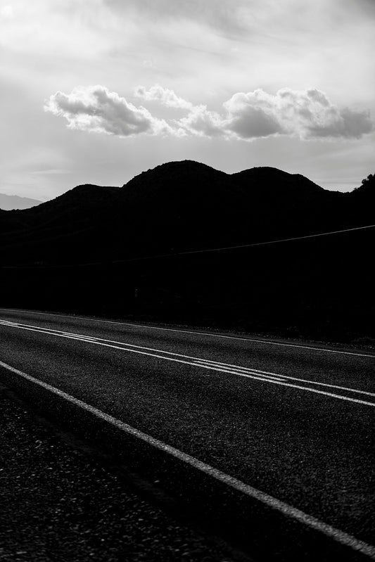 A moody and dark photograph in black and white of Route 62 in the Little Karoo