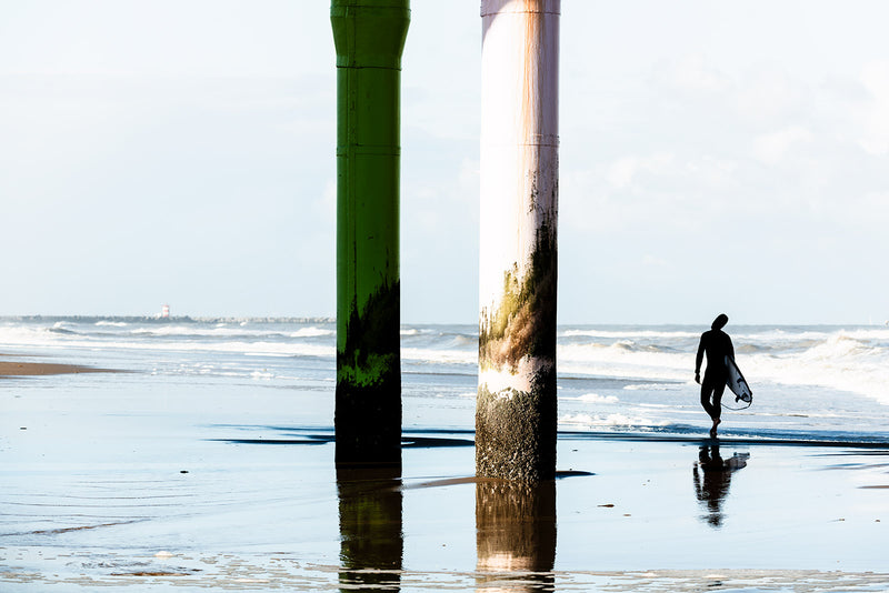 A surfer prepares to enter the North Sea.