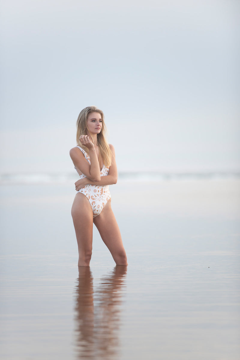Female model posing in shallow water.