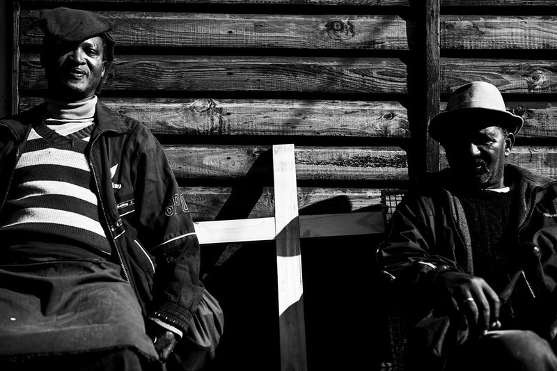 Documentary image of two men holding a cross.