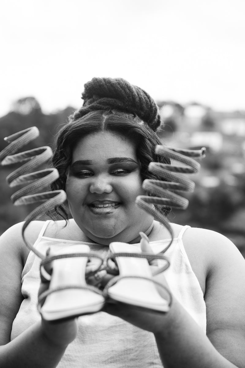 A young woman with her prom shoes.
