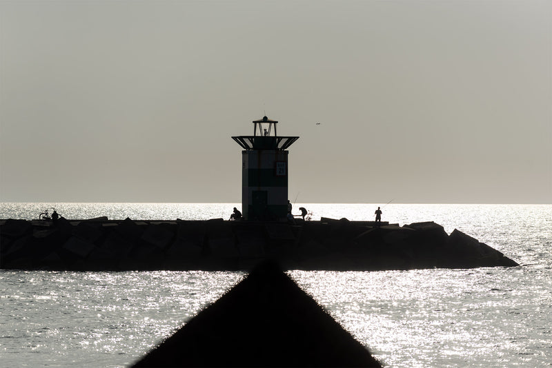 A view in sunset of the lighthouse at Scheveningen harbour.