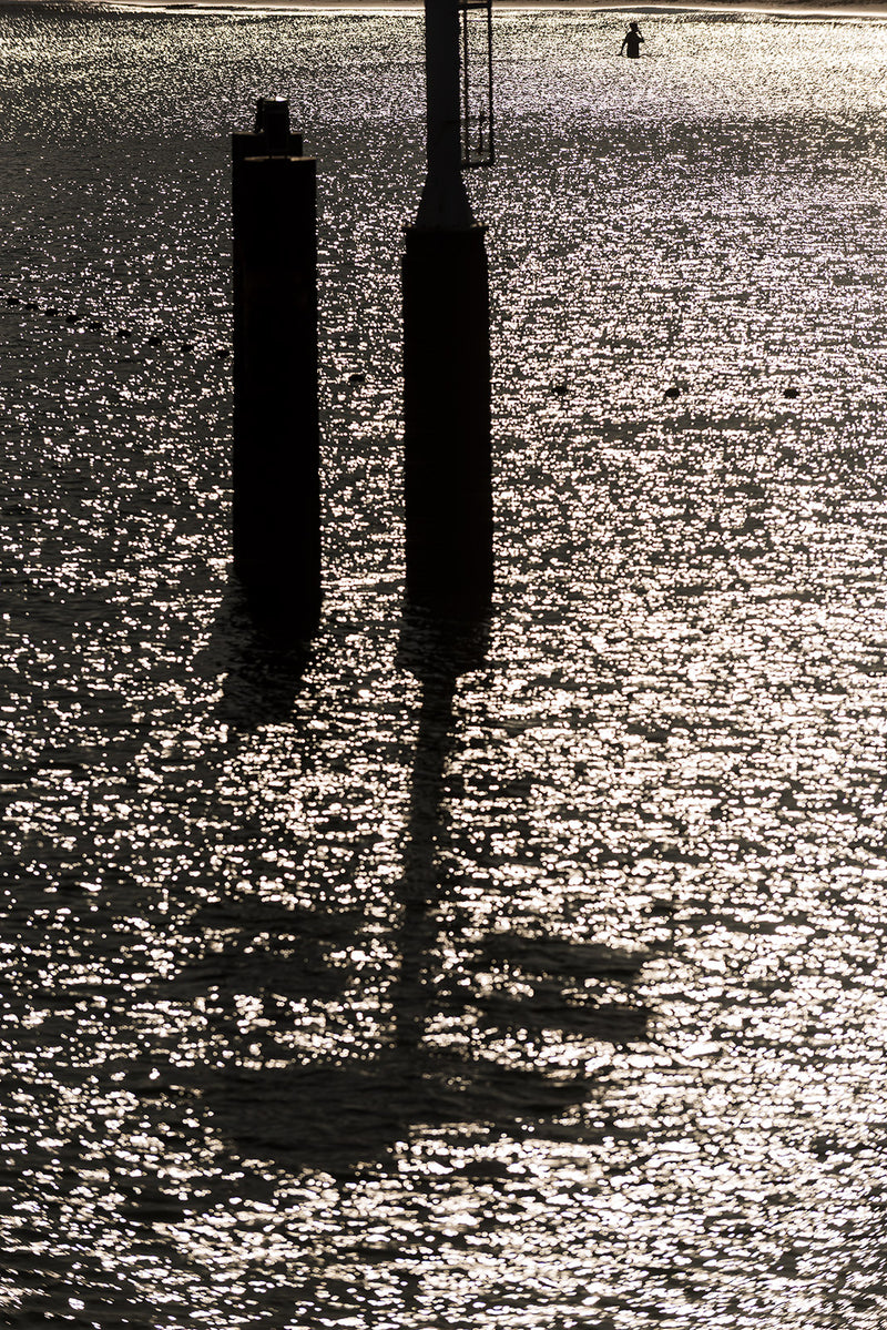 2 pillars rise out of the water.